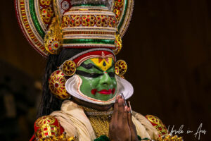 Portrait: Kathakali dancer in green face and white beard, Kerala Kathakali Centre, Fort Kochi, India