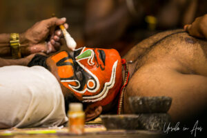 A man painting another man's face, Kerala Kathakali Centre, Fort Kochi, India