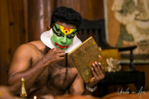 Man applying face paint, Kerala Kathakali Centre, Fort Kochi, India