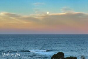 Full moon over pink clouds on the Pacific Ocean, Twofold Bay, Eden NSW Australia