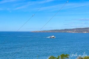 Tugboat spraying water in Snug Cove, Eden Australia