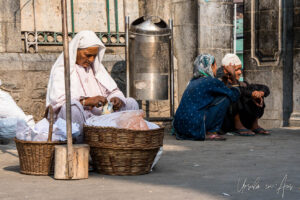 Old woman with a basket of packets for sale, on the street outside the Shah-e-Hamadan Mosque, Srinagar, Jammu and Kashmir, India.