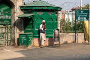 Man in a topi outside the Shah-e-Hamadan Mosque, Srinagar, Jammu and Kashmir, India.