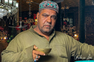 Portrait: Muslim man with a metal cup, Shah-e-Hamadan Mosque, Srinagar, Jammu and Kashmir, India.