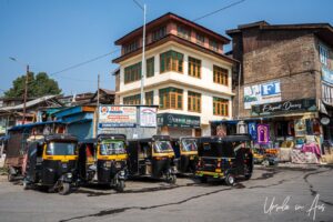 Shiny black and yellow tuk tuks waiting for customers, Srinagar, Jammu and Kashmir, India.