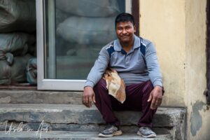 Man sitting on a stoop, Srinagar, Jammu and Kashmir, India.