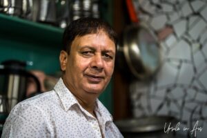 Environmental Portrait: man in a food shop, Old Srinagar, Jammu and Kashmir, India.