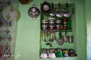 Metal pots and utensils on a green wall, Srinagar Nowhatta, Jammu and Kashmir, India.