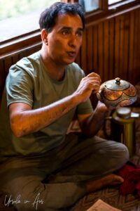 Craftsman painting a paper mache pot, Kawoosa Arts and Crafts, Srinagar, Jammu and Kashmir, India.