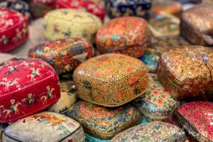 Small, colourfully decorated boxes made from paper mache, Kawoosa Arts and Crafts, Srinagar, Jammu and Kashmir, India.