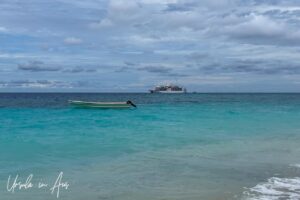 Ship on the deep blue waters beyond turquoise waters off Pulau Manim, West Papua Indonesia