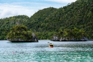 Kayakers in the islands, Pulau Wayag, Southwest Papua Indonesia