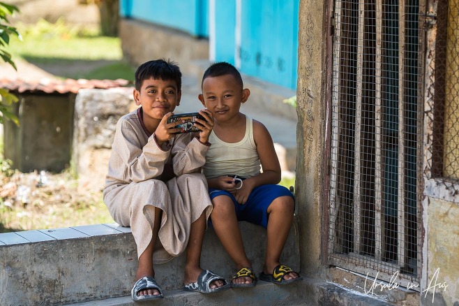 Environmental portrait: two young boys on the front step of a house, Doom, Southwest Papua, Indonesia.