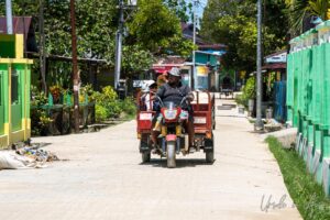 Man in a motorised pedicab, Doom, Southwest Papua, Indonesia.