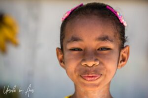 Environmental portrait: smiling young girl, Doom, Southwest Papua, Indonesia.