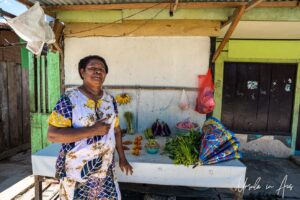 Papuan woman with fruit and vegetables for sale, Doom, Southwest Papua, Indonesia.