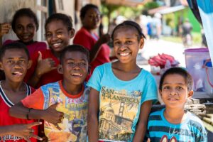 A group of local children mugging for the camera, Doom, Southwest Papua, Indonesia.
