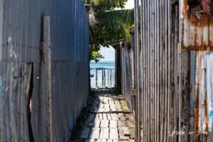 Views to the ocean between buildings, Doom, Southwest Papua, Indonesia.