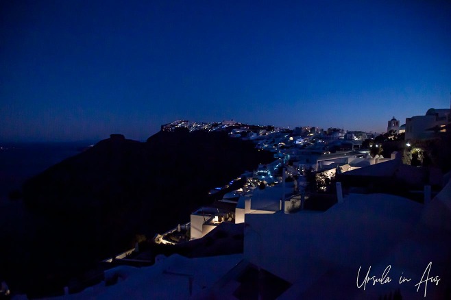 Looking north from Fira over the artificial lights of Santorini, Greece