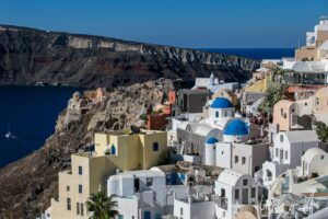 Dome of an Orthodox church with the Santorini caldera in the background, Oia Greece.