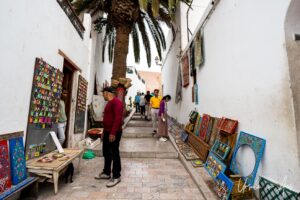 Paintings and rugs in a narrow lane, Rabat Morocco.