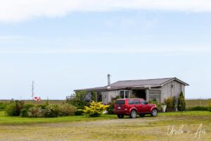 House and MPV on green lawn, Sandspit Airport, Moresby Island, Haida Gwaii BC Canada
