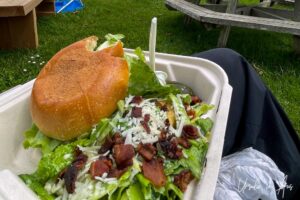 Burger and Caesar salad in a take-away tray, Moresby Island, Haida Gwaii BC Canada