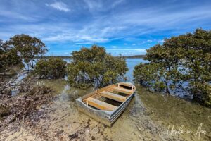 A small tinny on the low tide on Merimbula Lake, NSW Australia