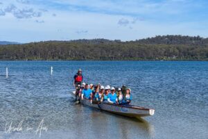 Women in a dragon boat, Lake Merimbula, NSW Australia.