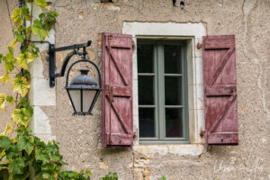 Wooden window shutters and an iron lamp, Saint-Cirq Lapopie, France
