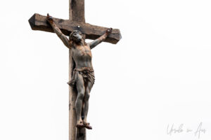 Large wooden crucifix against a white sky, Saint-Cirq Lapopie, France