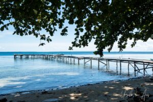 Wooden jetty over blue waters, Coral Triangle, Pulau Soop Indonesia