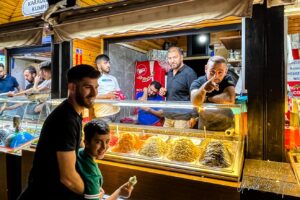 Men around a Kumpir stall, Ortaköy, Türkiye