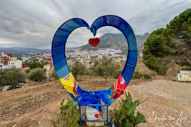 Heart-shaped selfie frame overlooking Chefchaouen, Morocco.