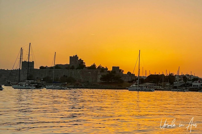 Orange sky silhouetting Bodrum Castle, Türkiye