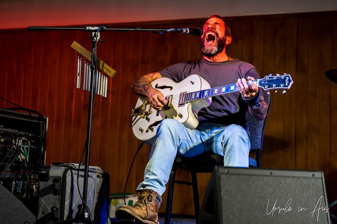 Mason Rack singing on stage, Kosci Room, Thredbo, Australia