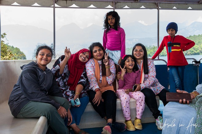 Indian family group on a boat, Anayirankal Dam, Idukki district, Kerala India
