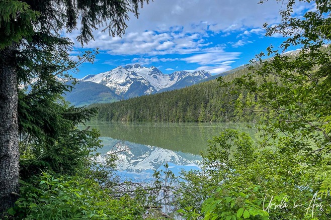 Snow capped mountains reflected in Lava Lake, Nisga