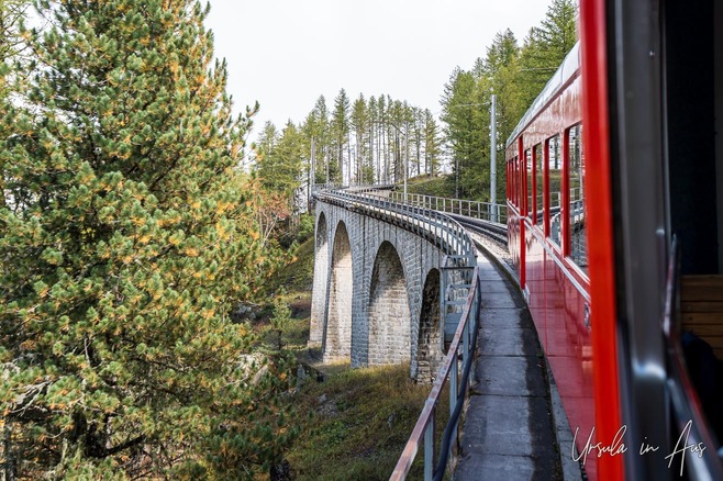 Red railway carriage on an elevated rail track, the Montenvers Railway, Chamonix, France 
