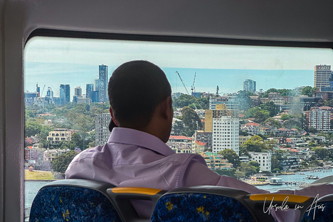View past a man on the phone to North Sydney from the train, NSW Australia