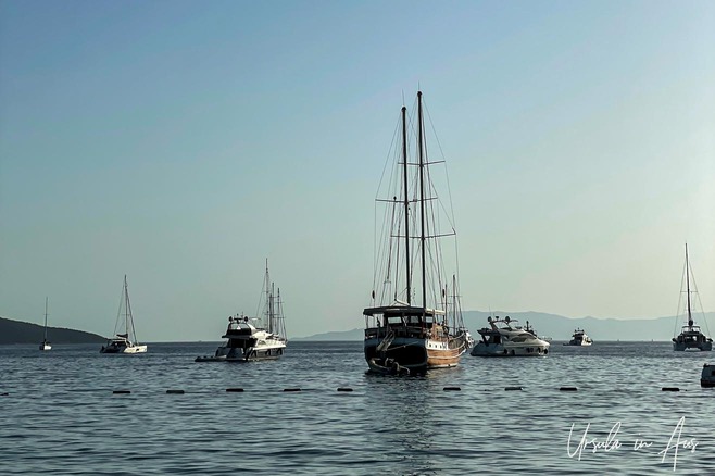 A gulet and several power boats anchored in Bodrum Harbour, Türkiye.