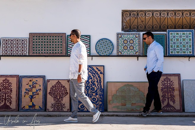 Men walking past large, colourful, tessellated ceramic art pieces, Art Naji, Fes Morocco