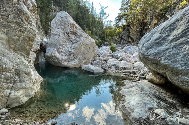 Boulders and rocks in crystal clear turquoise waters, Göynük Canyon, Türkiye.